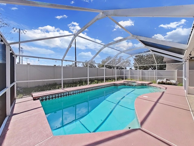 view of pool with a fenced in pool, glass enclosure, a patio, and a fenced backyard