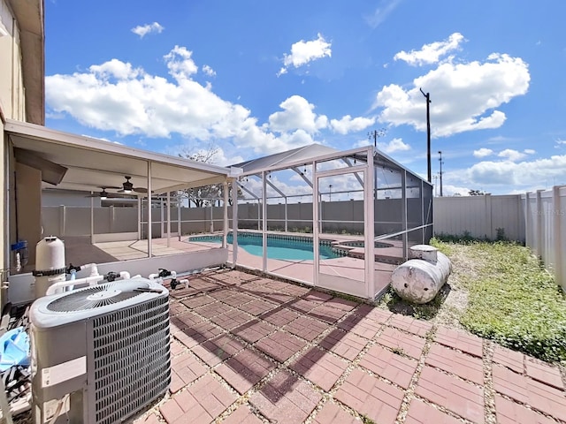 view of swimming pool featuring a fenced in pool, central AC unit, a patio area, glass enclosure, and a fenced backyard