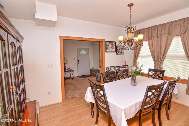 dining space featuring a notable chandelier and light hardwood / wood-style flooring