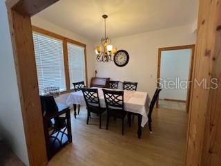 dining area with an inviting chandelier and hardwood / wood-style floors