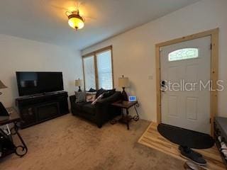 living room featuring carpet and a wealth of natural light