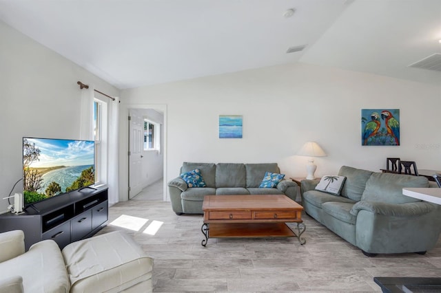 living room with lofted ceiling and light hardwood / wood-style flooring