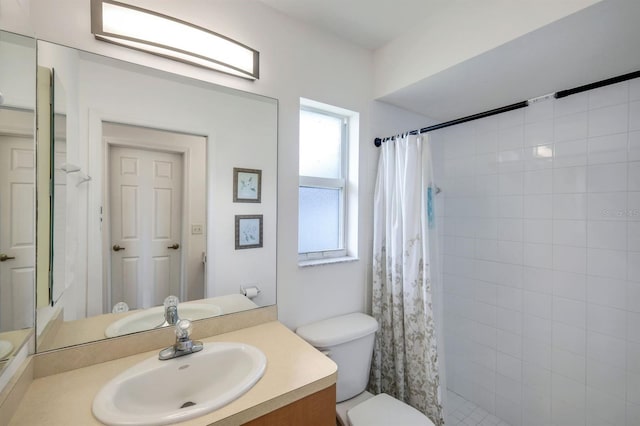 bathroom featuring vanity, toilet, and curtained shower