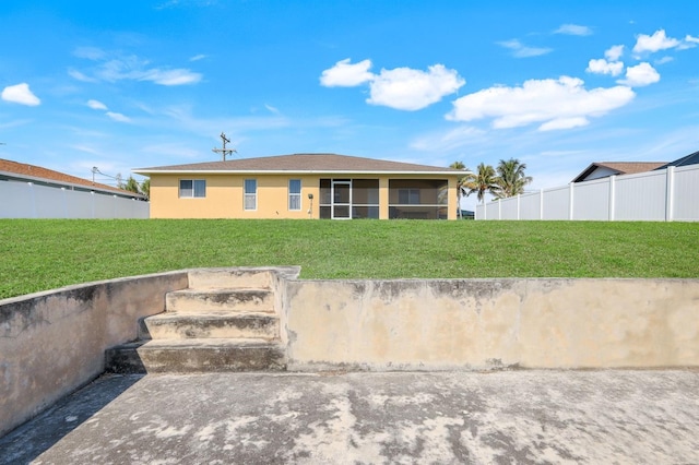 view of front of property with a front yard and a sunroom