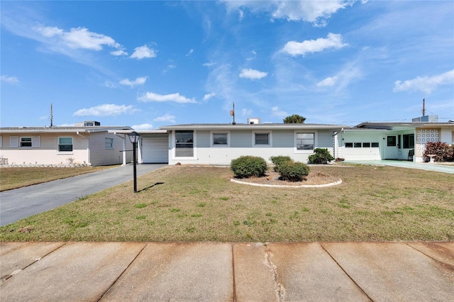 ranch-style house with a garage and a front yard