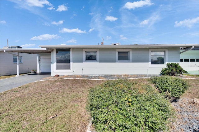 ranch-style house with a carport and a front yard