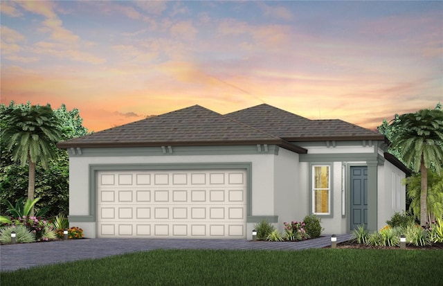 8635 SW 57th Ln, Ocala, FL 34481 - view of front facade featuring decorative driveway, a garage, roof with shingles, and stucco siding