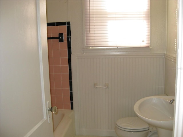 full bathroom with tiled shower / bath, toilet, and sink