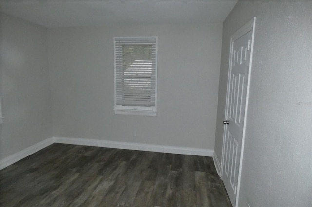 empty room featuring dark hardwood / wood-style flooring