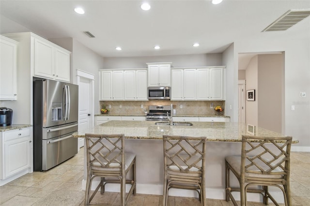 kitchen with appliances with stainless steel finishes, backsplash, visible vents, and recessed lighting