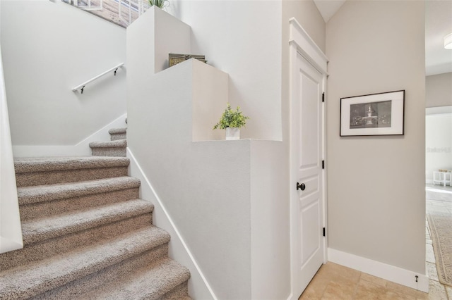 stairway featuring baseboards