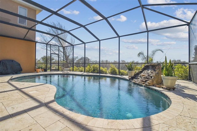 pool with glass enclosure and a patio area