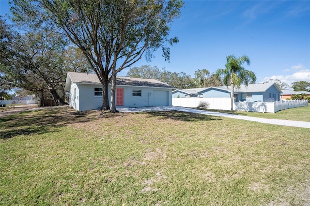 ranch-style home with concrete driveway, an attached garage, fence, a front lawn, and stucco siding