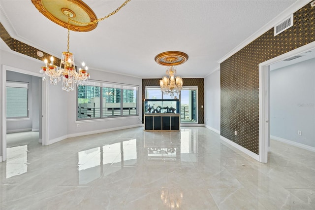 unfurnished dining area with ornamental molding and a chandelier