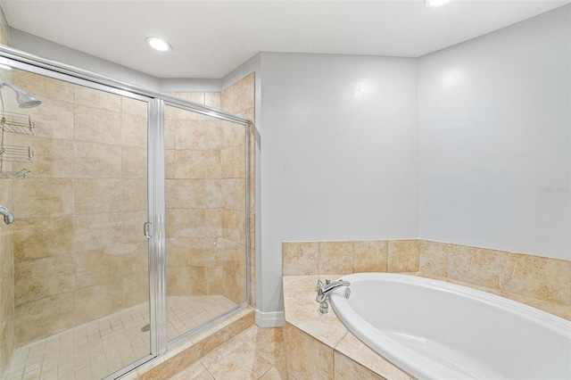 bathroom featuring tile patterned floors and separate shower and tub