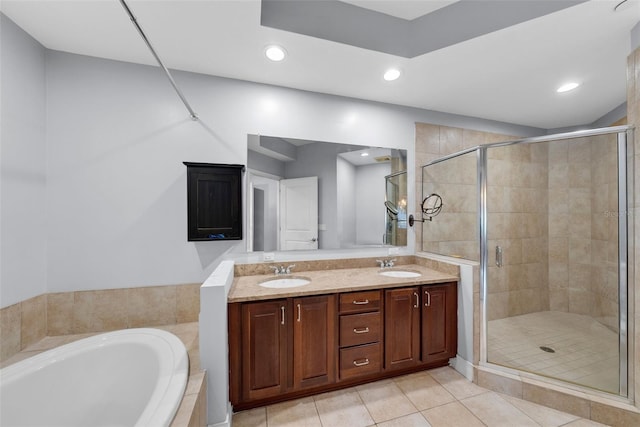 bathroom with tile patterned flooring, vanity, and separate shower and tub