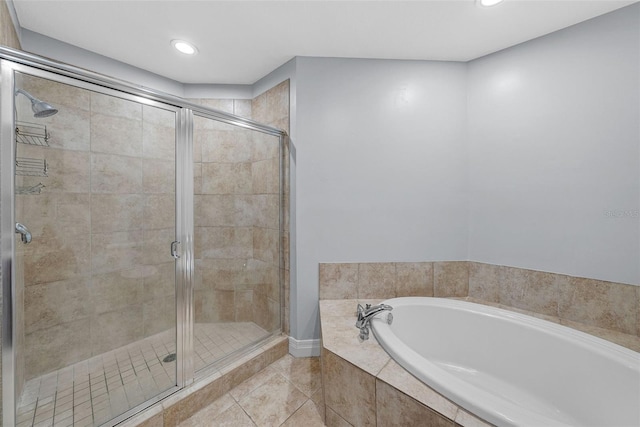 bathroom featuring shower with separate bathtub and tile patterned flooring