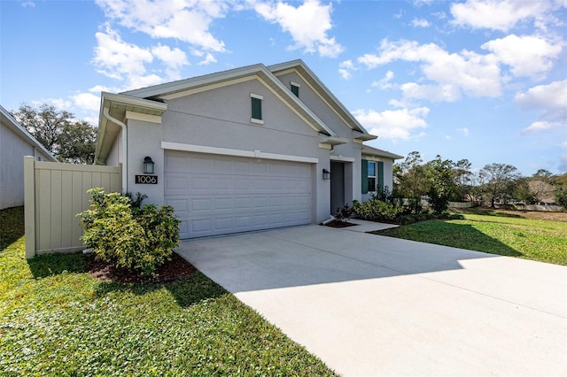 view of front of home with a garage and a front lawn