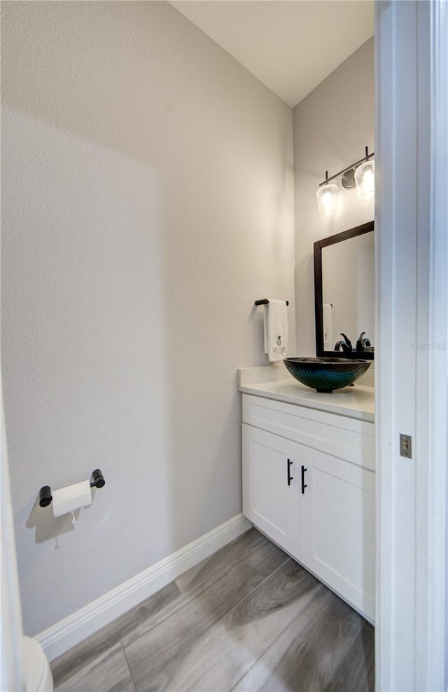 bathroom with vanity and hardwood / wood-style floors