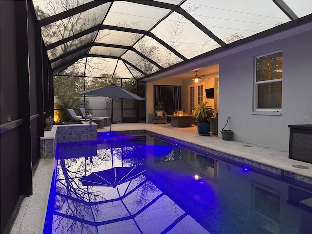 view of pool featuring a lanai, outdoor lounge area, ceiling fan, and a patio area