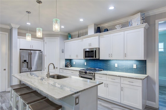 kitchen with a sink, crown molding, tasteful backsplash, and premium appliances