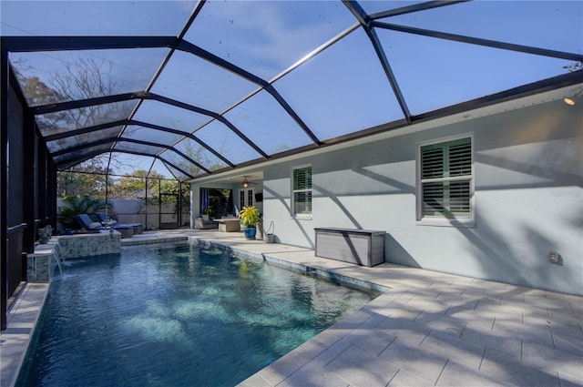 outdoor pool featuring a ceiling fan, a lanai, and a patio