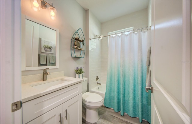 bathroom with toilet, wood finished floors, shower / tub combo with curtain, and vanity