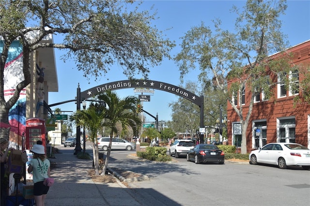 view of street with sidewalks, traffic lights, and curbs