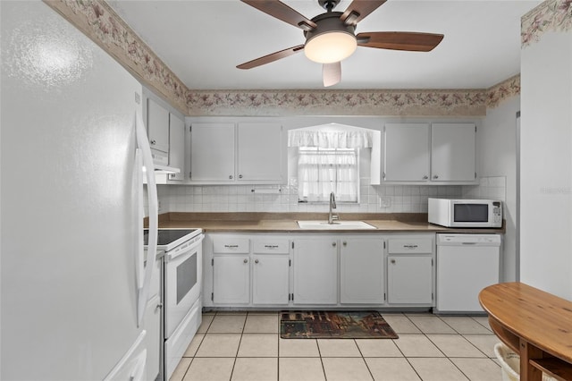 kitchen featuring light tile patterned flooring, sink, tasteful backsplash, ceiling fan, and white appliances