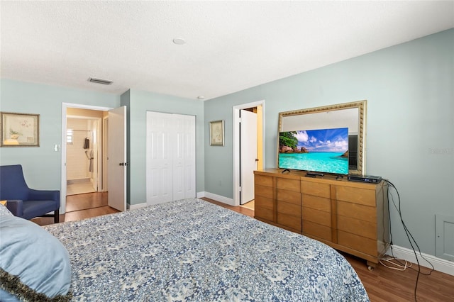 bedroom with hardwood / wood-style flooring and a textured ceiling