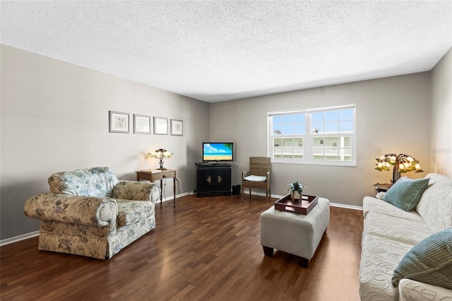 living room with dark hardwood / wood-style floors and a textured ceiling