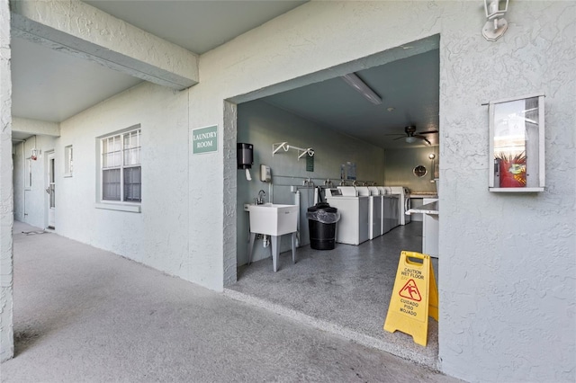 exterior space featuring sink, washer and clothes dryer, and ceiling fan