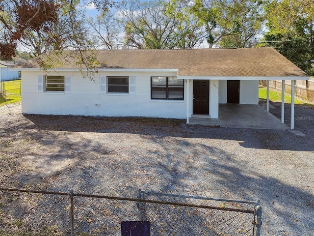 ranch-style house featuring a carport