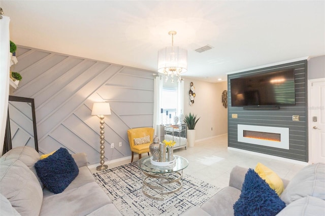 living room with an inviting chandelier and a large fireplace