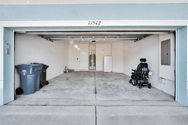 garage with a garage door opener, electric panel, electric water heater, and white fridge