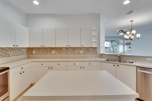 kitchen with decorative light fixtures, tasteful backsplash, sink, white cabinets, and stainless steel dishwasher