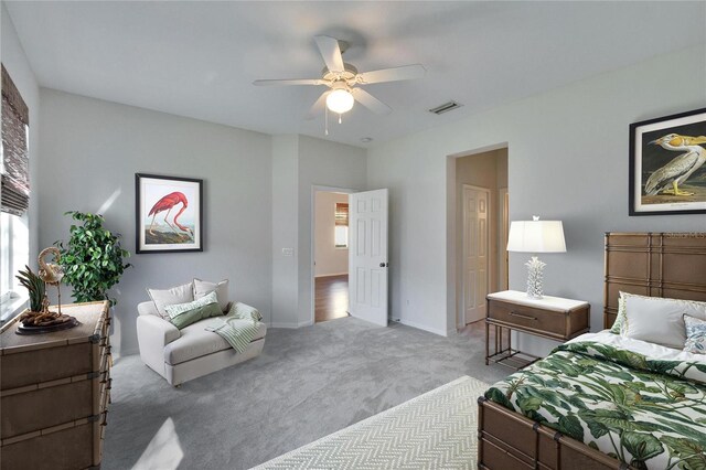 bedroom featuring ceiling fan and light carpet