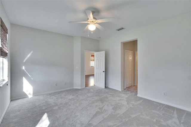 unfurnished bedroom featuring light carpet and ceiling fan