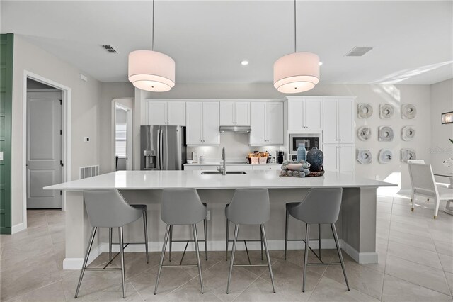 17020 Cape Horn Blvd, Punta Gorda, FL 33955 - kitchen with stainless steel refrigerator with ice dispenser, pendant lighting, sink, and white cabinets