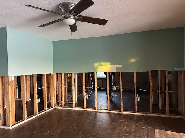 miscellaneous room featuring ceiling fan and a textured ceiling