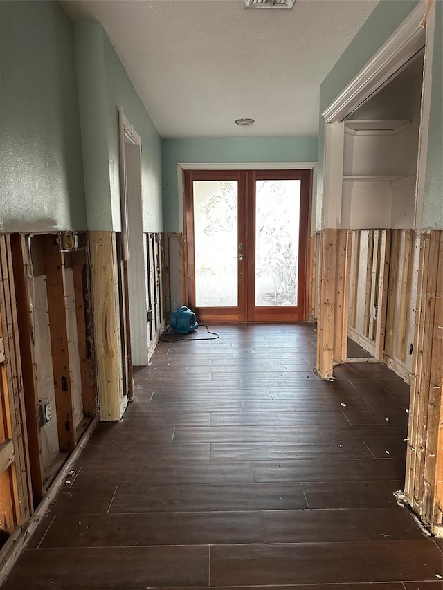 hall featuring dark wood-type flooring and french doors