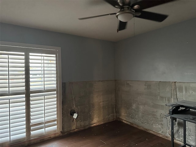 empty room featuring hardwood / wood-style flooring and ceiling fan