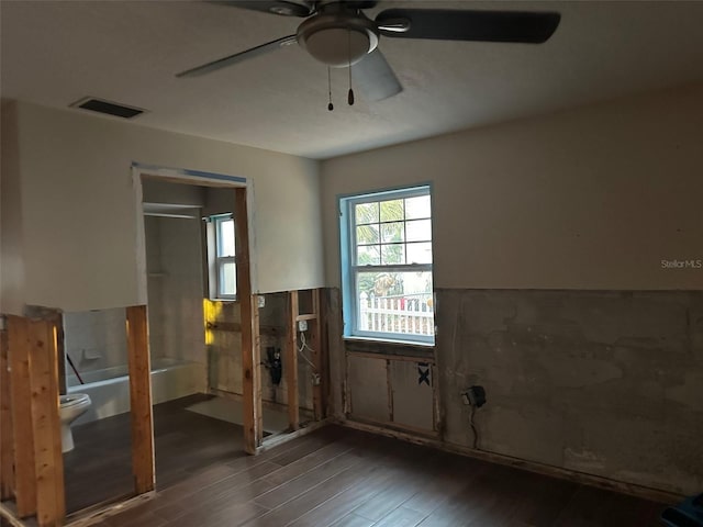 spare room with dark wood-type flooring and ceiling fan