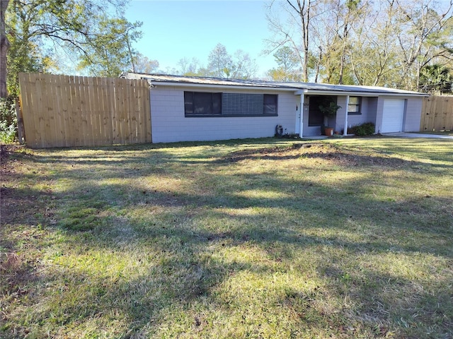 ranch-style home with a garage and a front lawn