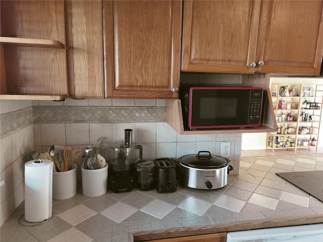 kitchen featuring dishwashing machine and backsplash