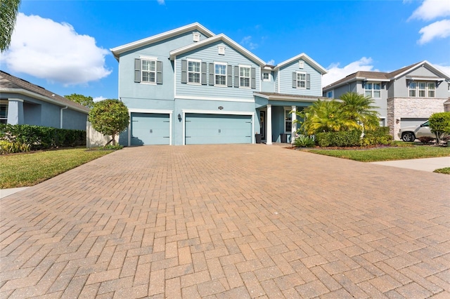 view of front of home featuring a garage and a front lawn