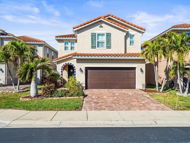 mediterranean / spanish-style home with a garage