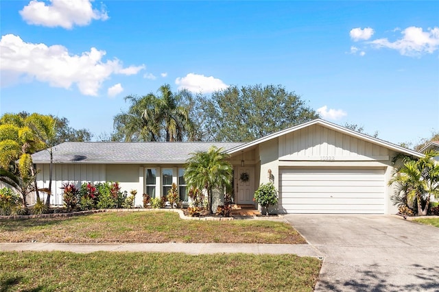 ranch-style house featuring a garage and a front yard