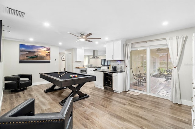 recreation room featuring wine cooler, billiards, ceiling fan, and light wood-type flooring