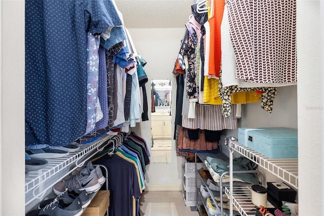 walk in closet with tile patterned flooring